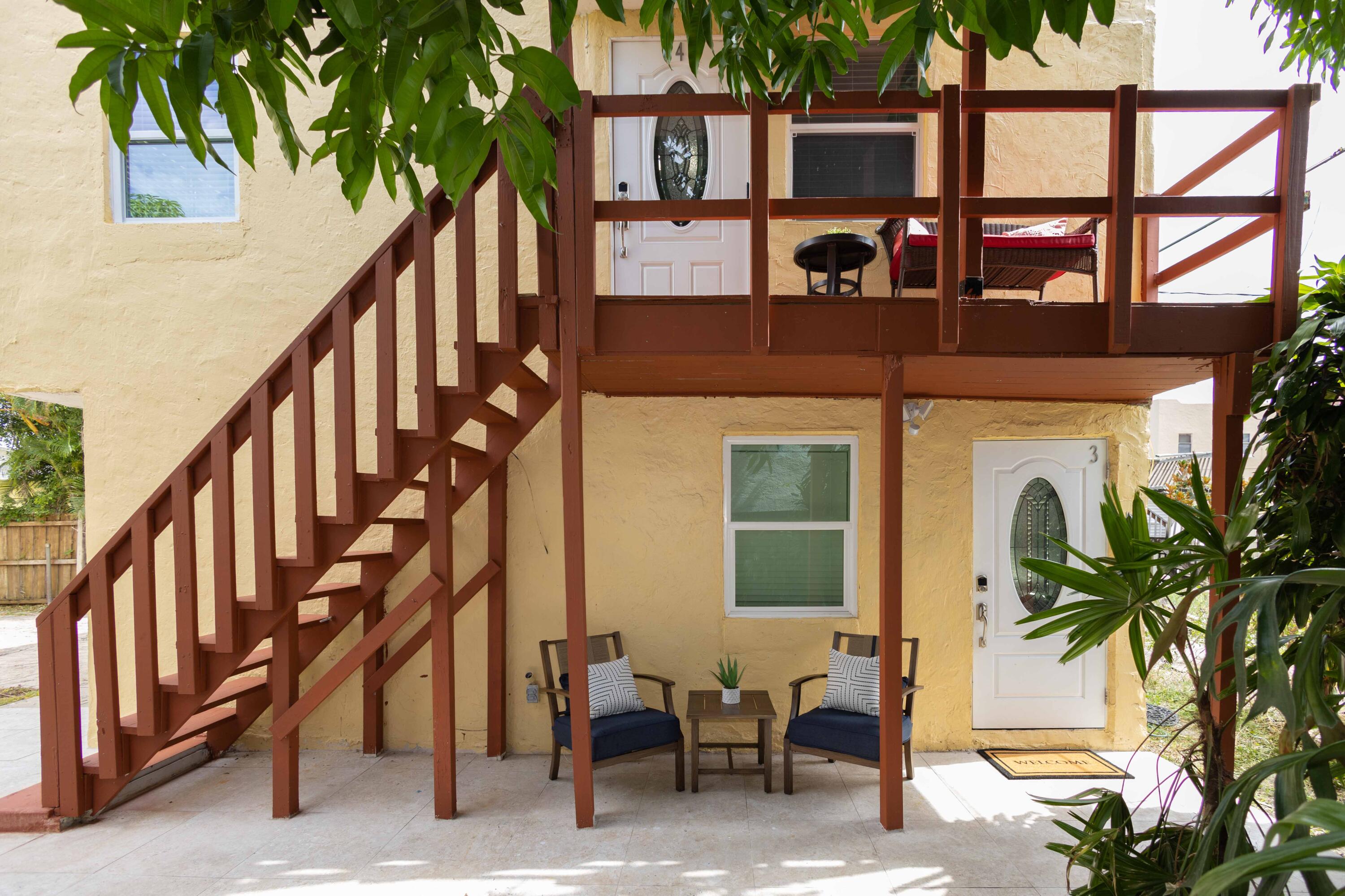 420 Avenida Alegre, Unit 4 West Palm Beach, FL 33405 - Photo 25 of 33 a front view of a house with outdoor seating and a potted plant