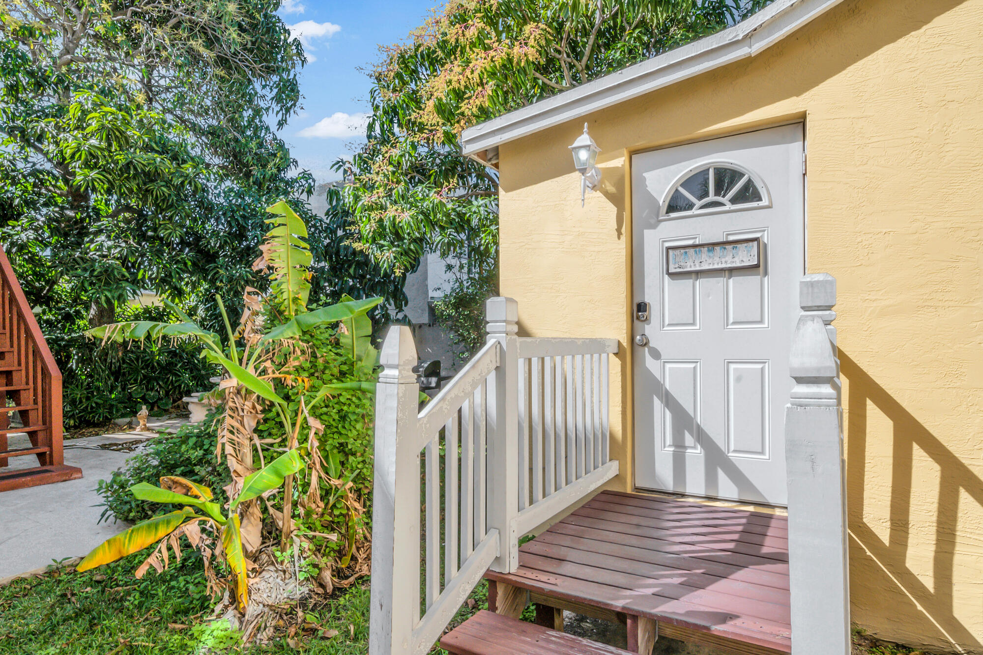 420 Avenida Alegre, Unit 4 West Palm Beach, FL 33405 - Photo 31 of 33 a view of a wooden house with a tree and wooden fence