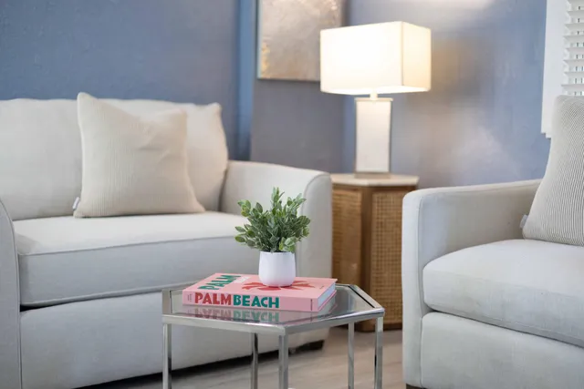 a living room with furniture and a lamp