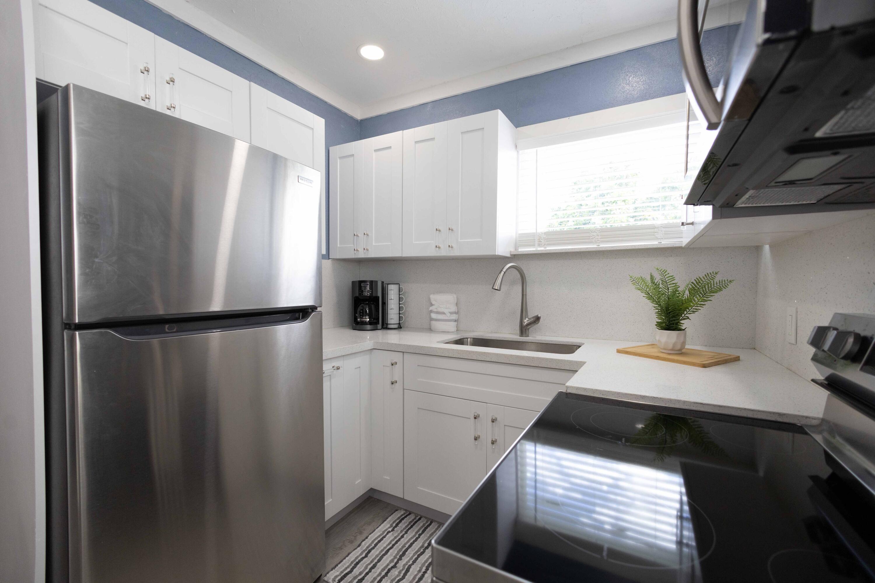 420 Avenida Alegre, Unit 4 West Palm Beach, FL 33405 - Photo 8 of 33 a kitchen with a refrigerator and a sink