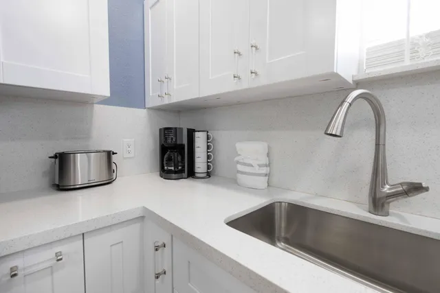 a kitchen with a sink and cabinets
