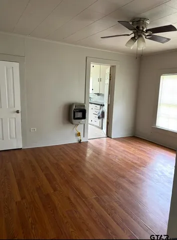 a view of empty room with wooden floor
