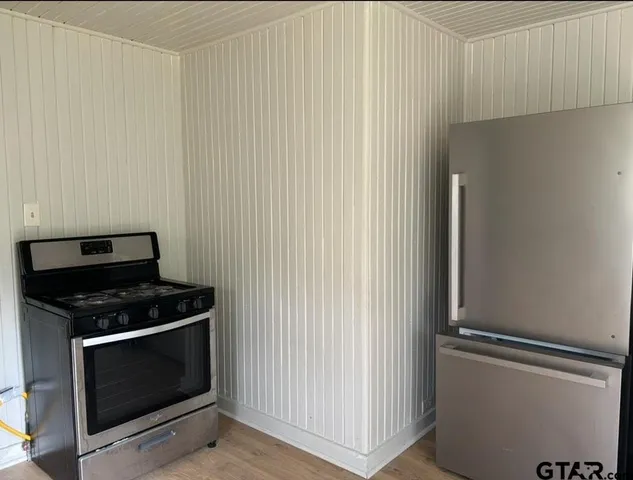 a stove top oven sitting inside of a kitchen