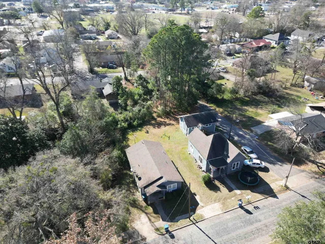 an aerial view of a house with outdoor space
