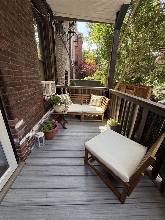 9 Albemarle Street, Unit 2 Boston, MA 02115 - Photo 9 of 11 a view of a deck with couches and wooden floor