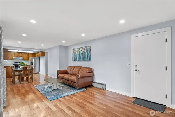 a living room with furniture and a wooden floor
