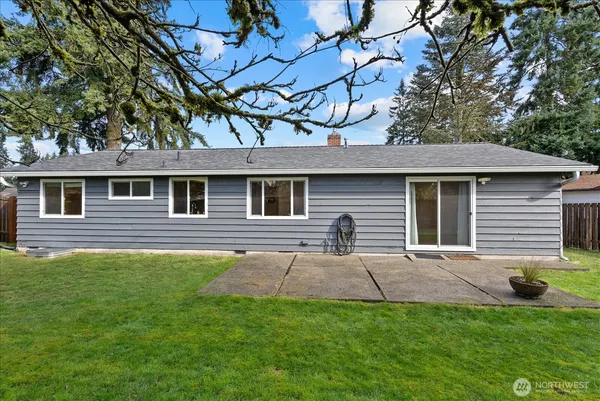 a front view of a house with yard tree and garage