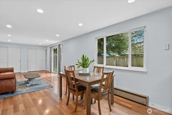 a dining room with furniture and wooden floor