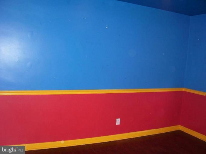 5464 Whitlock Road Baltimore, MD 21229 - Photo 2 of 6 a view of empty room with wooden floor