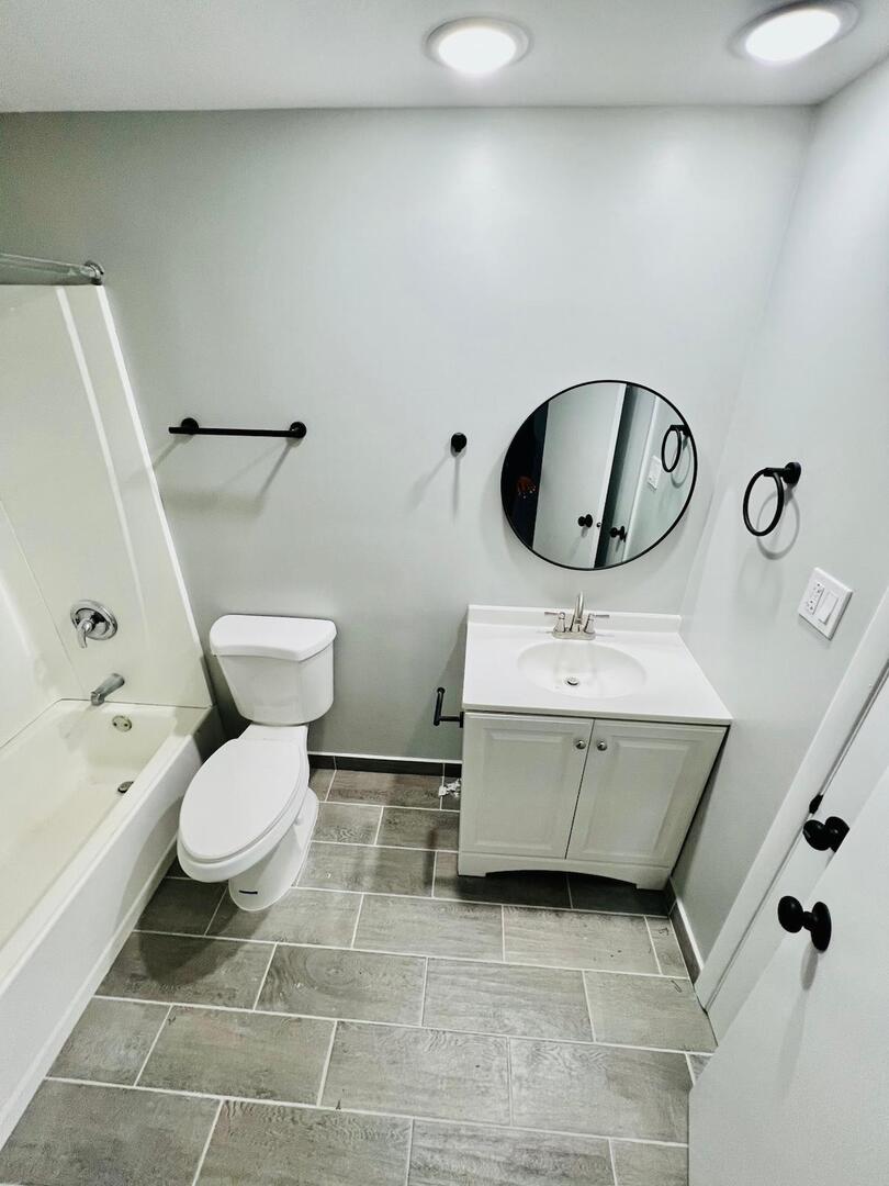 2021 Farnham Court Schaumburg, IL 60169 - Photo 13 of 16 a bathroom with a toilet sink and mirror