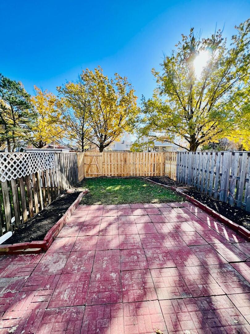 2021 Farnham Court Schaumburg, IL 60169 - Photo 16 of 16 a view of a backyard with wooden fence