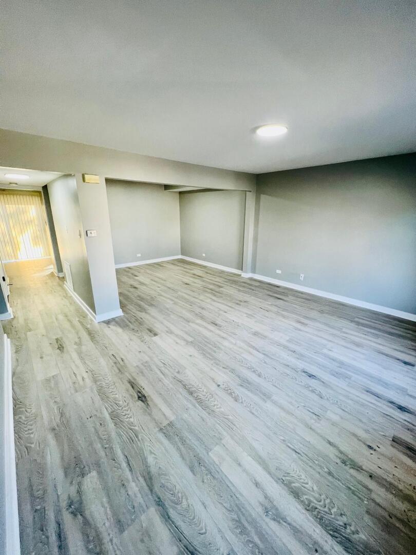 2021 Farnham Court Schaumburg, IL 60169 - Photo 3 of 16 an empty room with wooden floor and windows