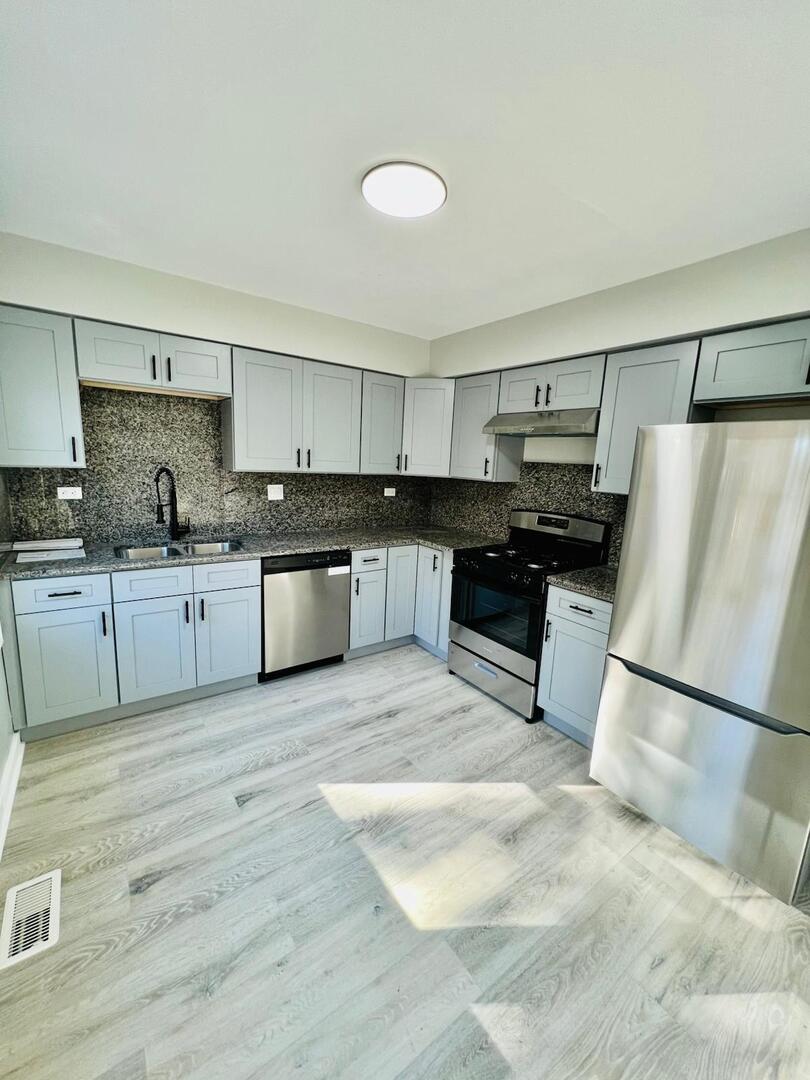 2021 Farnham Court Schaumburg, IL 60169 - Photo 6 of 16 a large kitchen with a cabinets and white appliances