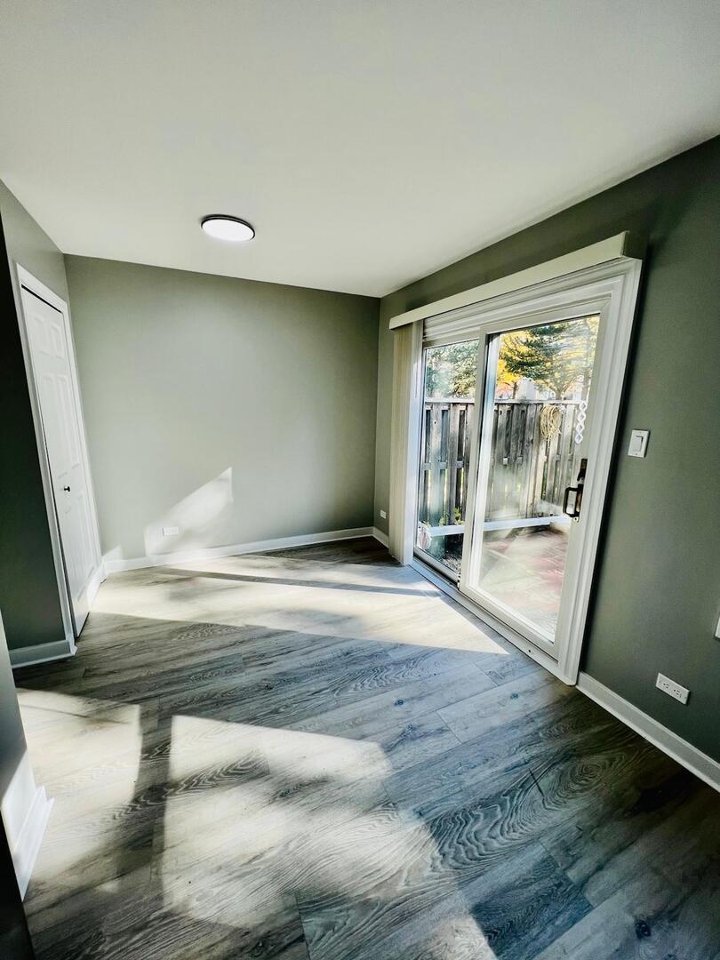 2021 Farnham Court Schaumburg, IL 60169 - Photo 7 of 16 a view of empty room with wooden floor and fan