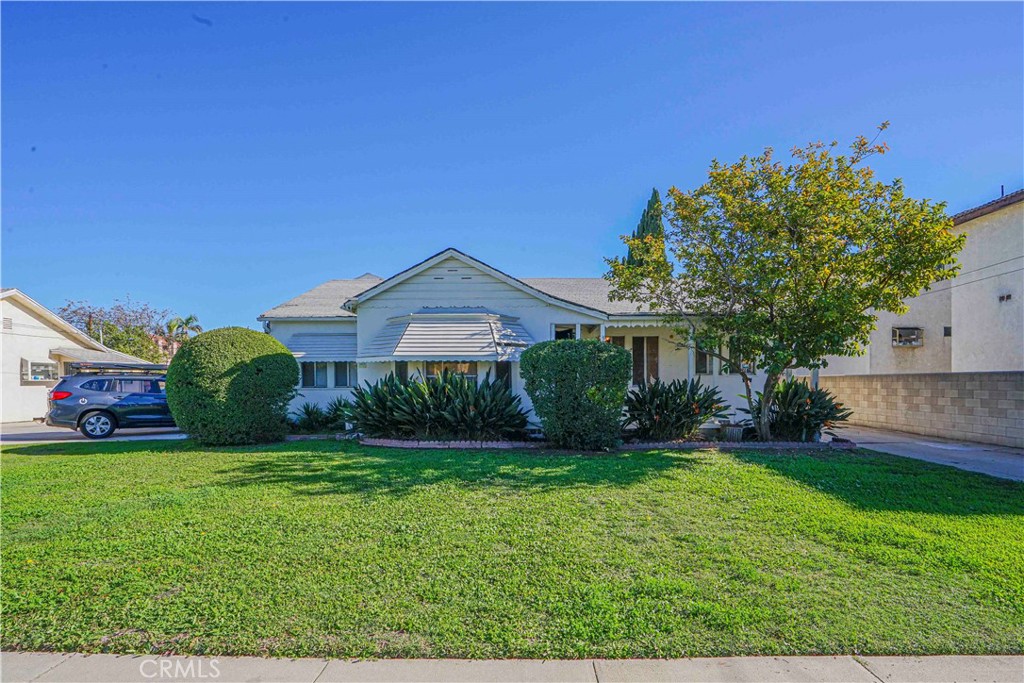 a front view of house with yard and green space