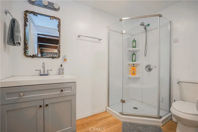 a bedroom with a bed a flat screen tv and dresser