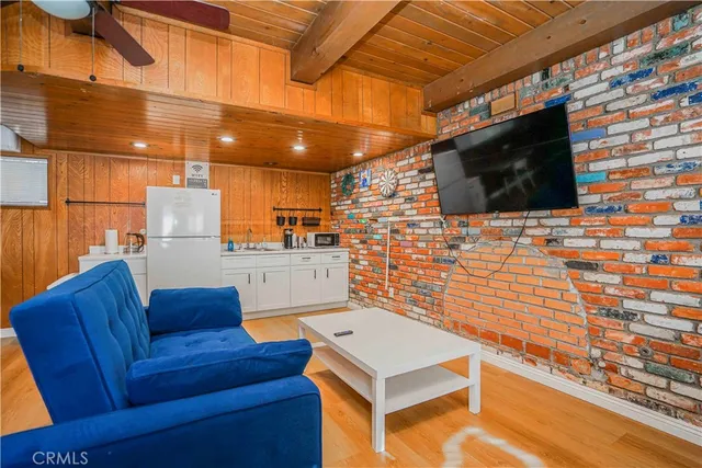 a bedroom with furniture and wooden floor