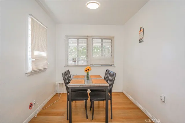 a dining room with furniture and wooden floor