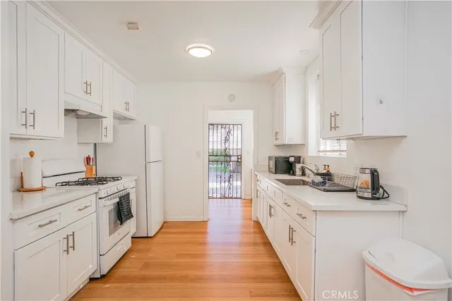 a kitchen with stainless steel appliances granite countertop a stove and a sink