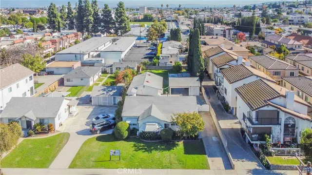 an aerial view of a house with a garden and trees