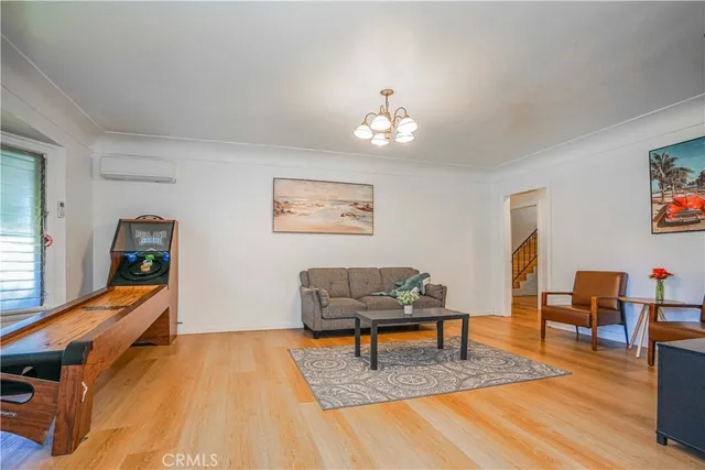 a living room with furniture and a chandelier