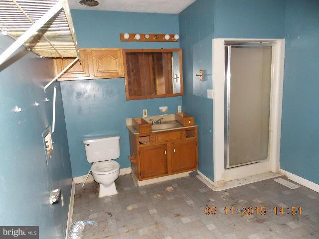 15745 Pratt Road Ridge, MD 20680 - Photo 11 of 12 a bathroom with a toilet sink and mirror