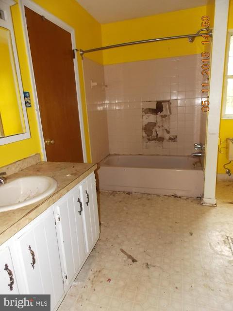 15745 Pratt Road Ridge, MD 20680 - Photo 12 of 12 a bathroom with a granite countertop sink a toilet and shower