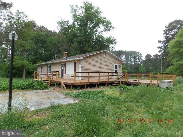 15745 Pratt Road Ridge, MD 20680 - Photo 3 of 12 a backyard of a house with table and chairs
