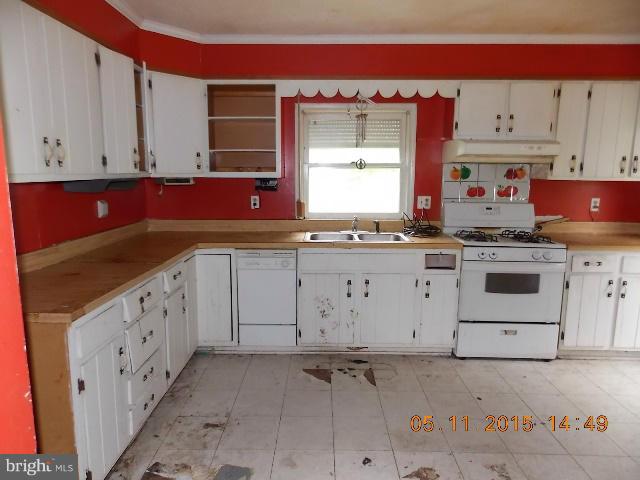 15745 Pratt Road Ridge, MD 20680 - Photo 7 of 12 a kitchen with cabinets appliances a sink and a counter top