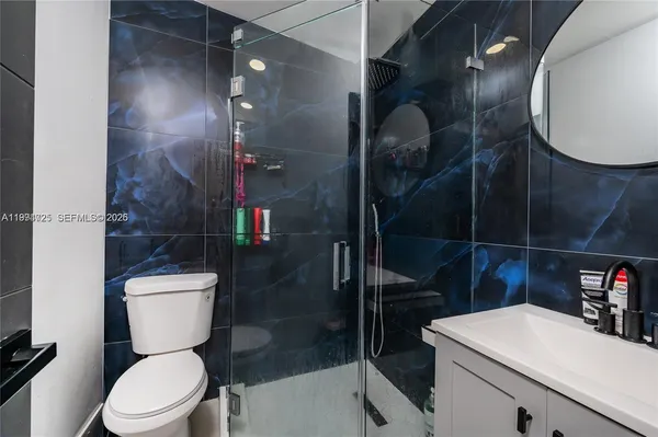 a bathroom with a toilet a sink and shower