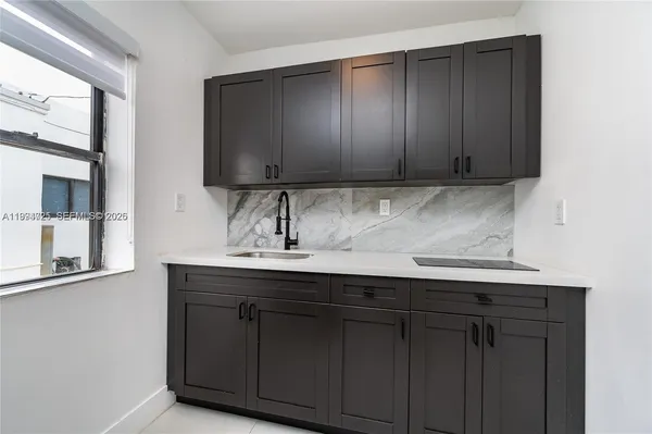 a kitchen with a sink and cabinets