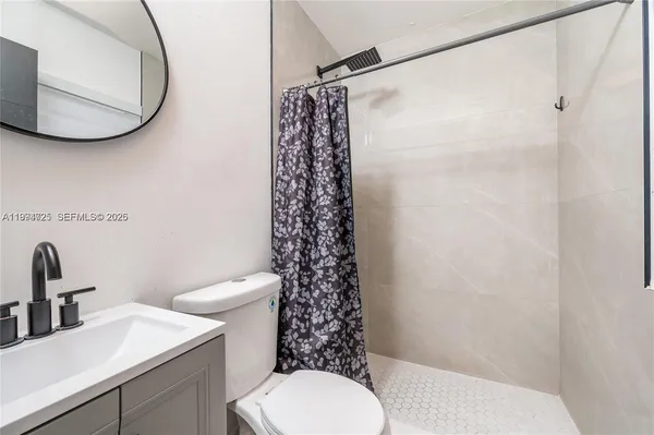 a bathroom with a sink toilet and a mirror