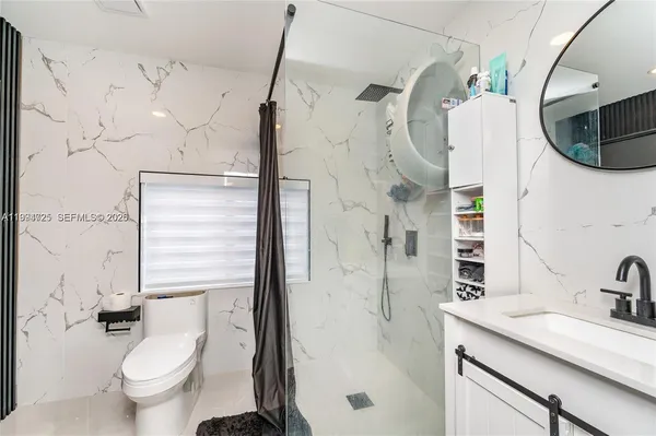 a bathroom with a sink toilet and shower