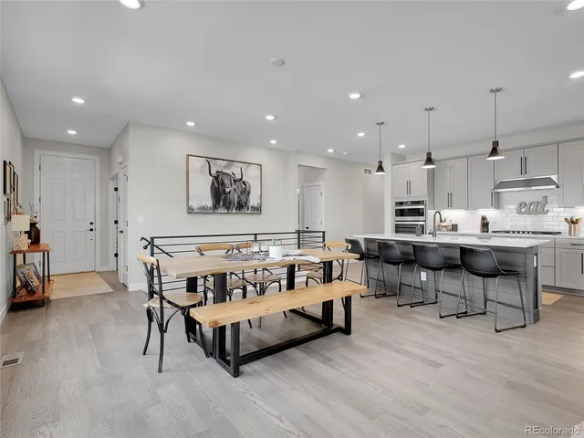 a living room with furniture and kitchen view