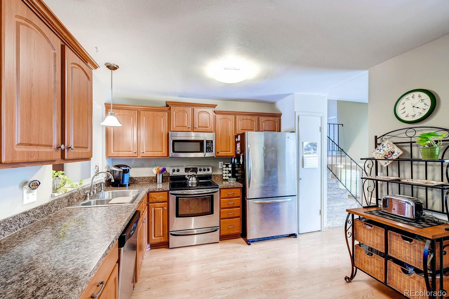 9862 Decatur Street Denver, CO 80260 - Photo 1 of 28 a kitchen with stainless steel appliances granite countertop a refrigerator a stove a sink and a microwave
