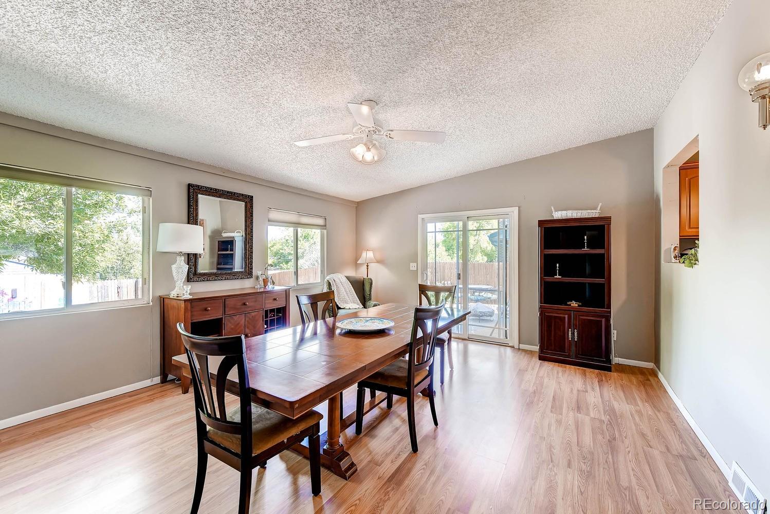 9862 Decatur Street Denver, CO 80260 - Photo 5 of 28 a view of a dining room with furniture window and wooden floor