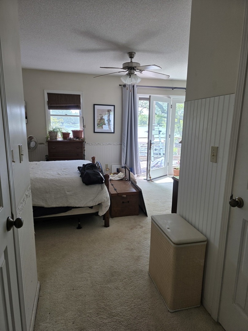 107 Comanche Trail Loda, IL 60948 - Photo 14 of 37 a bedroom with a bed and a chandelier