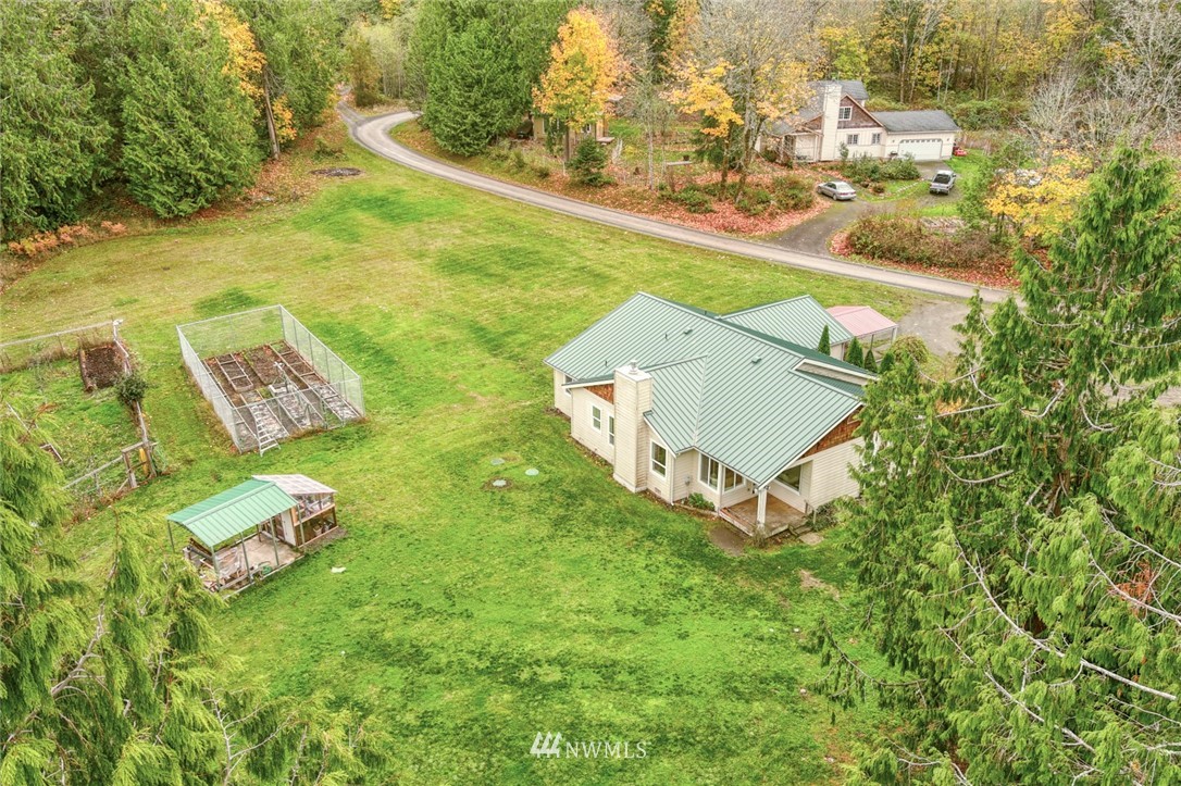 384 Sugar Hill Road Port Hadlock, WA 98339 - Photo 4 of 36 an aerial view of a house with a yard and trees