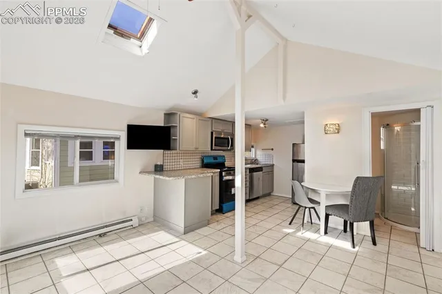 a kitchen with cabinets and chairs