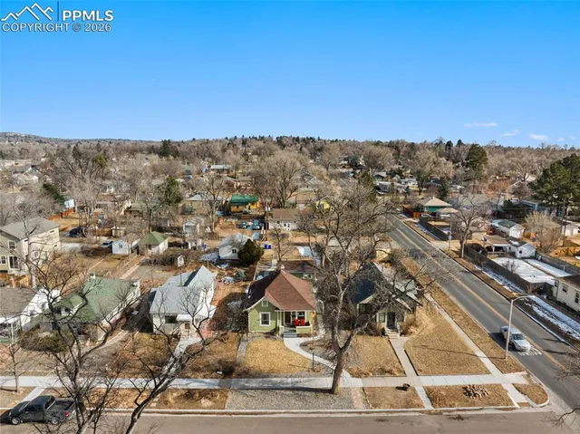 an aerial view of residential houses with city view
