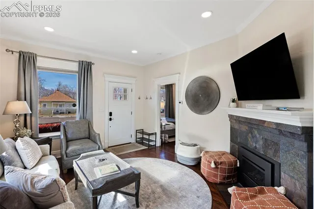 a living room with furniture a flat screen tv and a fireplace