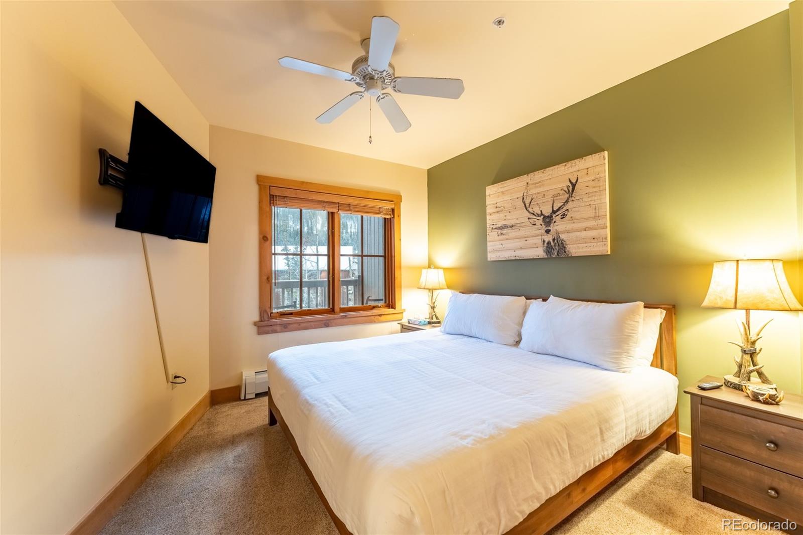 135 Dercum Drive, Unit 8595 Keystone, CO 80435 - Photo 13 of 33 a bedroom with a bed a flat screen tv and a chandelier