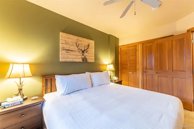 a bedroom with a bed and lamp