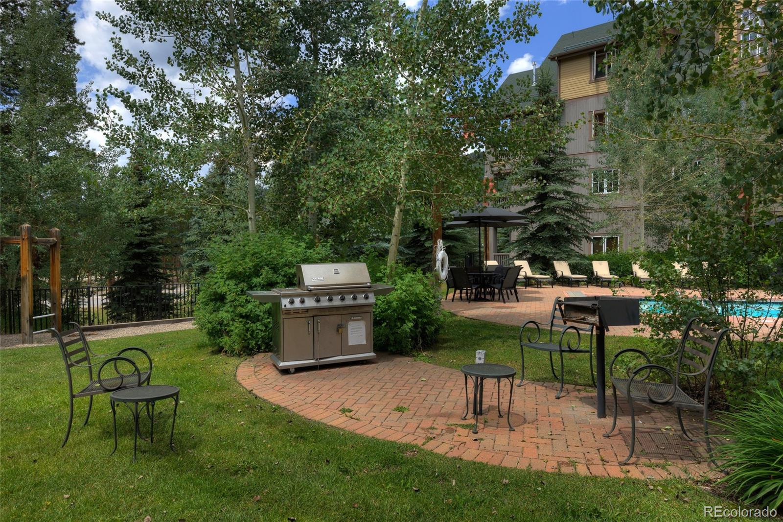 135 Dercum Drive, Unit 8595 Keystone, CO 80435 - Photo 31 of 33 a view of a chair and table in backyard of the house