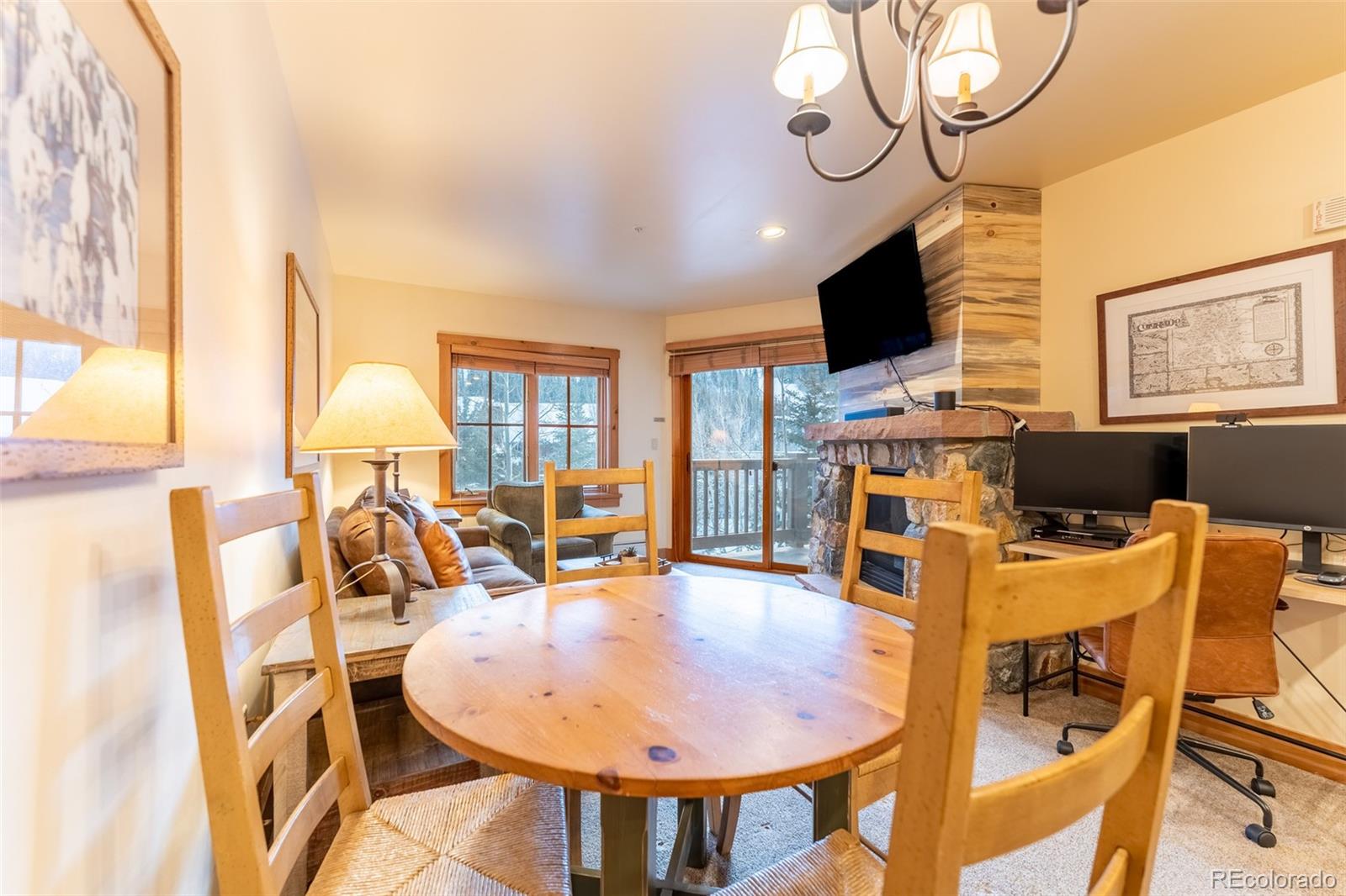 135 Dercum Drive, Unit 8595 Keystone, CO 80435 - Photo 5 of 33 a view of a dining room with furniture wooden floor and chandelier