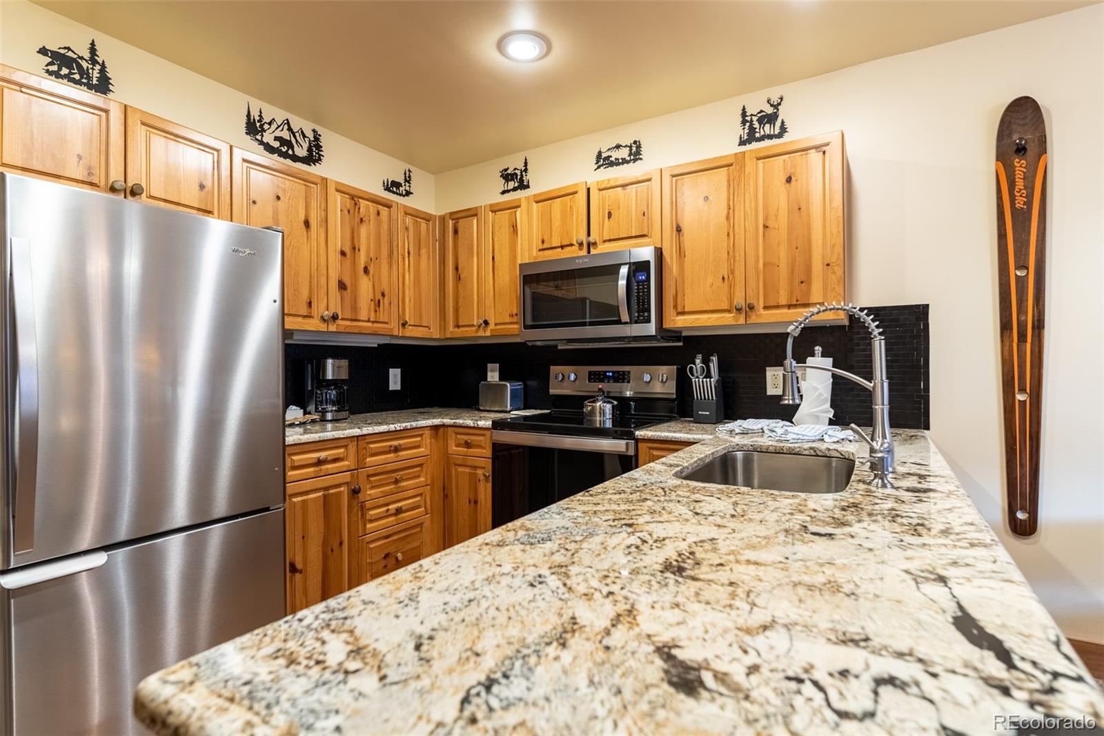 135 Dercum Drive, Unit 8595 Keystone, CO 80435 - Photo 6 of 33 a kitchen with stainless steel appliances granite countertop a refrigerator a stove top oven and a sink