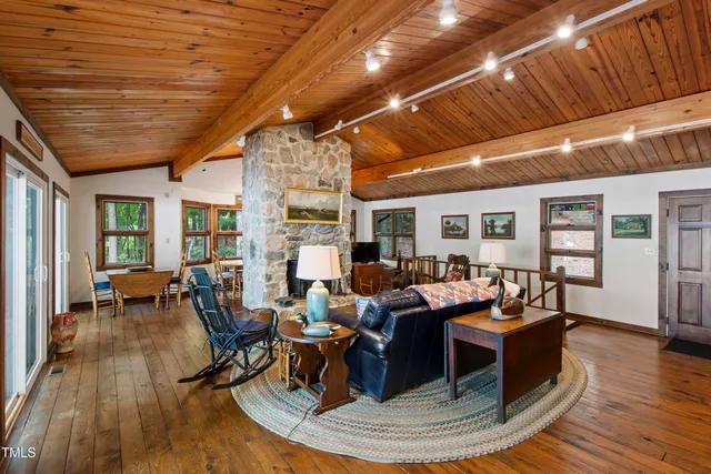 a living room with furniture large window and a fireplace