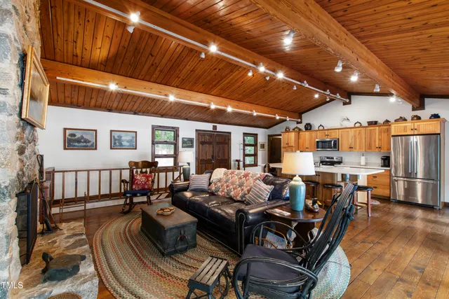 a dining room with furniture a chandelier and wooden floor