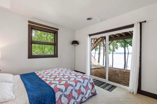 a view of a patio with table and chairs potted plants with wooden floor and fence