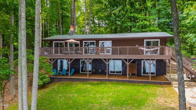 a view of a house with pool and a big yard